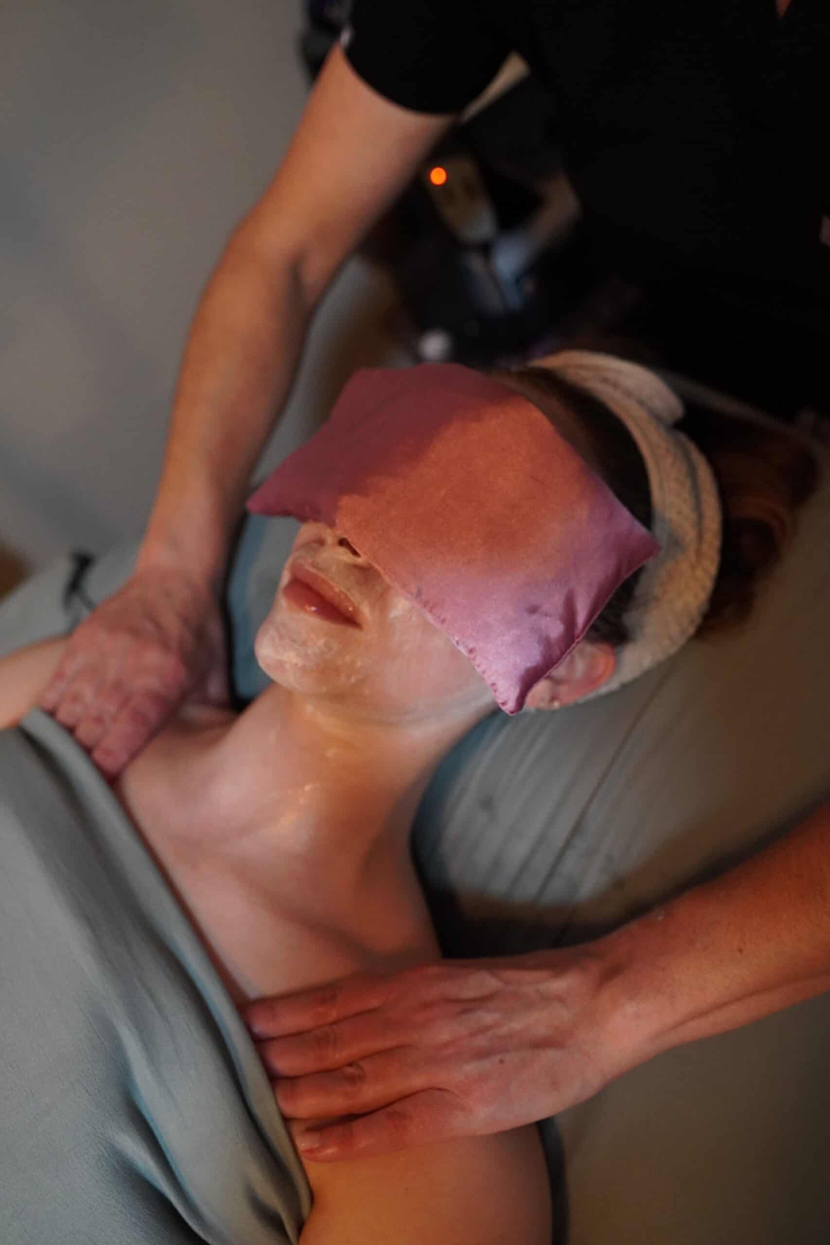 Patient receiving a customized Illuminate Facial at Illume Aesthetics — relaxed, warm treatment environment